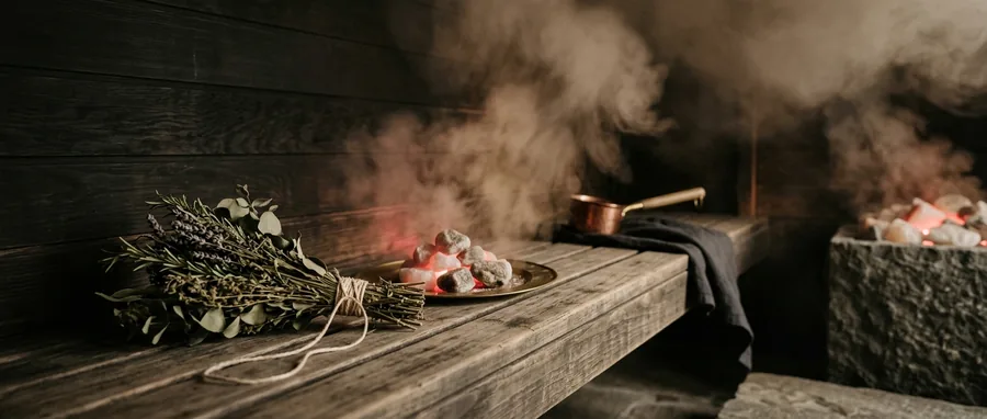 Herbal steam rising in a timber chamber