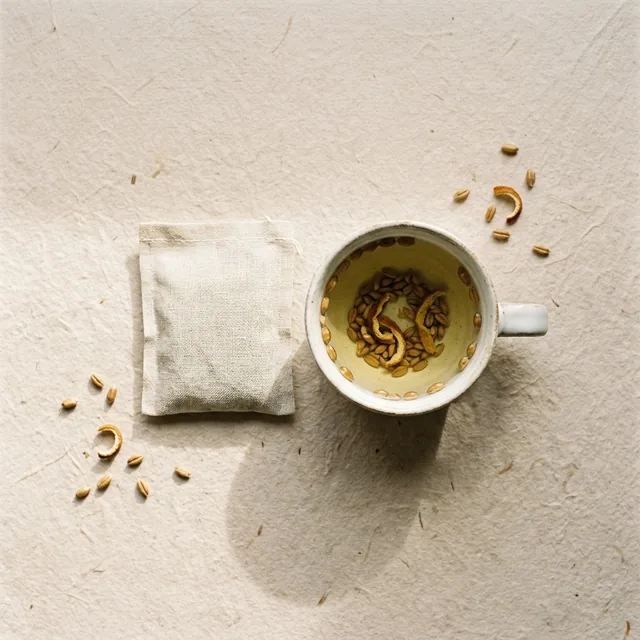 Lightness wellness tea, a sachet beside a cup on handmade paper